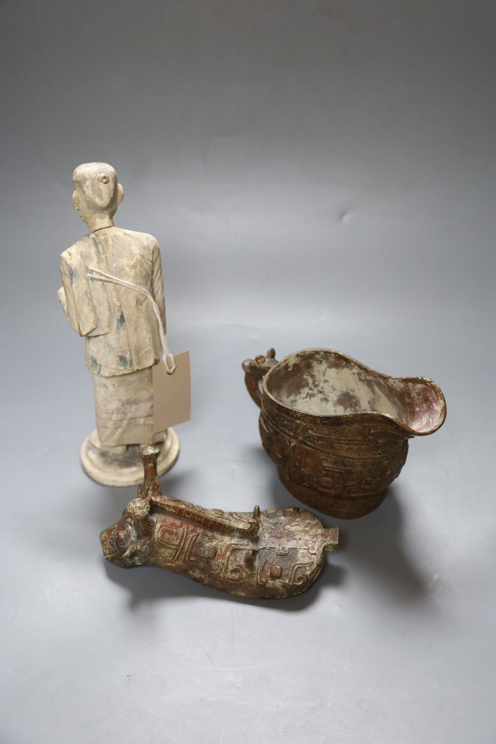 A Chinese archaistic bronze vessel, a Chinese carved wood figure and a cinnabar lacquer mount
